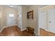 Inviting foyer features hardwood floors and a view of the front door and adjacent hallway with storage at 420 Carsons Creek Trl, Wendell, NC 27591