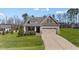 Charming home with a manicured lawn, covered porch, and a driveway leading to the attached garage at 420 Carsons Creek Trl, Wendell, NC 27591