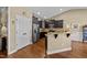 Kitchen features stainless steel appliances, granite countertops, dark cabinets, and hardwood floors at 420 Carsons Creek Trl, Wendell, NC 27591