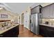 Kitchen features stainless steel appliances, granite countertops, dark cabinets, and hardwood floors at 420 Carsons Creek Trl, Wendell, NC 27591