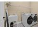 Functional laundry room with a utility sink, modern washer and dryer, and shelving for organization at 420 Carsons Creek Trl, Wendell, NC 27591