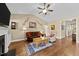 Comfortable living room with hardwood floors, a fireplace, and ample seating perfect for relaxation at 420 Carsons Creek Trl, Wendell, NC 27591