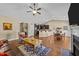 Spacious open-concept living area with a fireplace, hardwood floors, and a dining area in the background at 420 Carsons Creek Trl, Wendell, NC 27591
