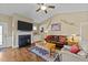Cozy living room with a fireplace, plush sofa, and vaulted ceilings for comfortable lounging at 420 Carsons Creek Trl, Wendell, NC 27591