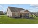 The home's rear exterior with well-manicured lawn, covered porch, and simple landscaping provides a serene backdrop at 420 Carsons Creek Trl, Wendell, NC 27591