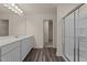Modern bathroom showcasing gray cabinets, neutral walls, and a glass shower at 44 Rolling Banks Dr, Louisburg, NC 27549