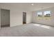 Spacious bedroom with plush carpet, neutral walls, and two entry doors at 44 Rolling Banks Dr, Louisburg, NC 27549