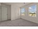 Well-lit bedroom with neutral paint and two windows at 44 Rolling Banks Dr, Louisburg, NC 27549