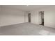 Spacious bedroom featuring neutral paint, carpet, and doors with lots of natural light at 44 Rolling Banks Dr, Louisburg, NC 27549