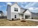 Charming two-story home with light gray siding and a well-manicured lawn against a clear blue sky at 44 Rolling Banks Dr, Louisburg, NC 27549