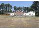 Charming single-story home featuring a welcoming covered porch and beautiful architectural details at 44 Rolling Banks Dr, Louisburg, NC 27549