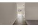Hallway featuring wood flooring and a view into the living room with glass sliding doors at 44 Rolling Banks Dr, Louisburg, NC 27549