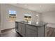 Spacious kitchen with a granite countertop island, stainless steel dishwasher, and abundant natural light at 44 Rolling Banks Dr, Louisburg, NC 27549