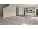 Open-concept living room showing the staircase, kitchen, and modern flooring at 44 Rolling Banks Dr, Louisburg, NC 27549