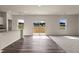 Bright living room with wood floors and sliding glass doors to the backyard at 44 Rolling Banks Dr, Louisburg, NC 27549