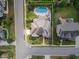 An aerial view showcases a home's roof, pool, landscaping, lawn and surrounding street in a well maintained neighborhood at 5026 Clyden Cv, Raleigh, NC 27612