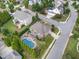 Aerial view of a large home with an in-ground pool, patio area, and manicured landscaping at 5026 Clyden Cv, Raleigh, NC 27612