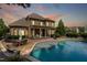 Luxury backyard featuring a spacious brick patio, outdoor seating, and a sparkling in-ground pool at 5026 Clyden Cv, Raleigh, NC 27612