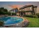 Beautiful in-ground pool surrounded by brick pavers and lush landscaping in a private backyard at 5026 Clyden Cv, Raleigh, NC 27612