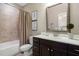 Well-lit bathroom with vanity, framed mirror, and shower with a tub at 5026 Clyden Cv, Raleigh, NC 27612