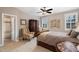 Inviting bedroom with a ceiling fan, plantation shutters, a spacious closet, and comfortable seating area at 5026 Clyden Cv, Raleigh, NC 27612