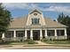 Charming community clubhouse with large columns, inviting entryway, and beautifully maintained front lawn at 5026 Clyden Cv, Raleigh, NC 27612