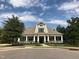 Beautiful community clubhouse featuring classic architectural details, a covered porch and well-manicured landscaping at 5026 Clyden Cv, Raleigh, NC 27612