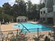Inviting community pool area with a lap lane, lovely landscaping, a pool house and ample seating at 5026 Clyden Cv, Raleigh, NC 27612