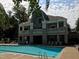 Resort-style community pool with ample seating and a clubhouse with second story balconies overlooking the water at 5026 Clyden Cv, Raleigh, NC 27612