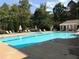 Large, serene community pool with lush surrounding landscaping, ideal for relaxation and recreation at 5026 Clyden Cv, Raleigh, NC 27612