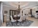 Dining room featuring neutral decor, decorative ceiling, and views into the living room at 5026 Clyden Cv, Raleigh, NC 27612