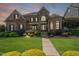 Charming exterior of a stone and brick home with a beautifully landscaped front yard at 5026 Clyden Cv, Raleigh, NC 27612