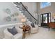Elegant foyer with staircase, tiled floor, and natural light at 5026 Clyden Cv, Raleigh, NC 27612