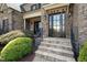 Inviting front entrance with stone steps and decorative door at 5026 Clyden Cv, Raleigh, NC 27612