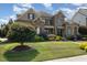 Inviting stone and brick home with manicured lawn, mature trees, and tasteful landscaping at 5026 Clyden Cv, Raleigh, NC 27612