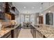 Gourmet kitchen featuring granite countertops, stainless steel appliances, and a breakfast nook with bright, natural light at 5026 Clyden Cv, Raleigh, NC 27612