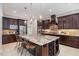 Gourmet kitchen with stainless steel appliances, granite countertops, an island, and a wine rack at 5026 Clyden Cv, Raleigh, NC 27612