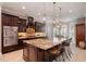 Gourmet kitchen with stainless steel appliances, granite countertops, an island, and dark wood cabinets at 5026 Clyden Cv, Raleigh, NC 27612