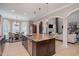 Open kitchen with granite countertops, stainless appliances and spacious island with views of the dining and living areas at 5026 Clyden Cv, Raleigh, NC 27612