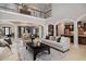 Open-concept living room showcasing neutral decor, an upper balcony, and views into the dining and kitchen areas at 5026 Clyden Cv, Raleigh, NC 27612