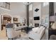 Bright living room featuring tall ceilings, neutral decor, fireplace, and views into the kitchen at 5026 Clyden Cv, Raleigh, NC 27612