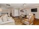 Spacious living room with hardwood floors, multiple seating areas, and a TV, perfect for gatherings at 5026 Clyden Cv, Raleigh, NC 27612