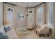 Bright sitting room with neutral walls, crown molding, arched windows and plantation shutters offers a cozy and elegant space at 5026 Clyden Cv, Raleigh, NC 27612