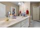 Bathroom with double sinks, white cabinets, and a large mirror at 715 Thompson Rd, Garner, NC 27529