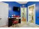Blue bedroom with a tv and view to the sink and vanity area at 715 Thompson Rd, Garner, NC 27529