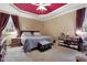 Spacious bedroom with a king bed, neutral carpet, and red ceiling at 715 Thompson Rd, Garner, NC 27529