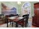 Elegant dining room with a chandelier, wooden table, and a large window providing natural light at 715 Thompson Rd, Garner, NC 27529