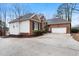 Lovely home with an attached garage and manicured shrubs surrounding a long, paved driveway at 715 Thompson Rd, Garner, NC 27529
