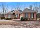 Charming single Gathering home featuring brick exterior, black shutters, and manicured landscaping at 715 Thompson Rd, Garner, NC 27529