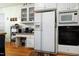 Kitchen with white appliances, cabinets, and wood countertops for a traditional feel at 715 Thompson Rd, Garner, NC 27529